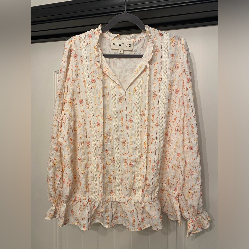 Hiatus peasant sleeve top with lace detail.